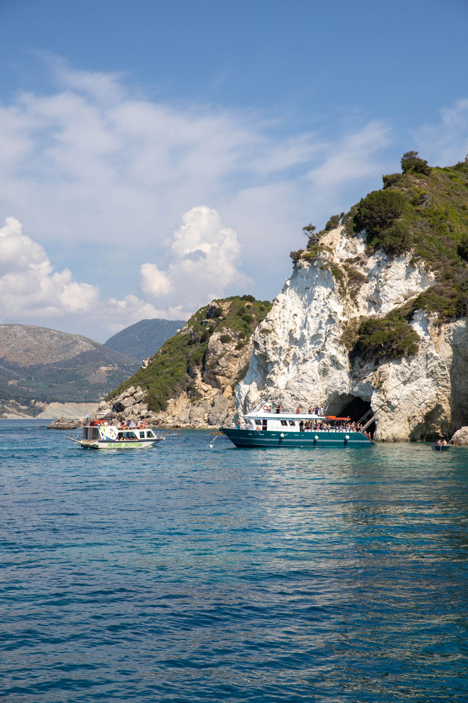 Tour boats near Zakynthos cliffs on a full-day island route
