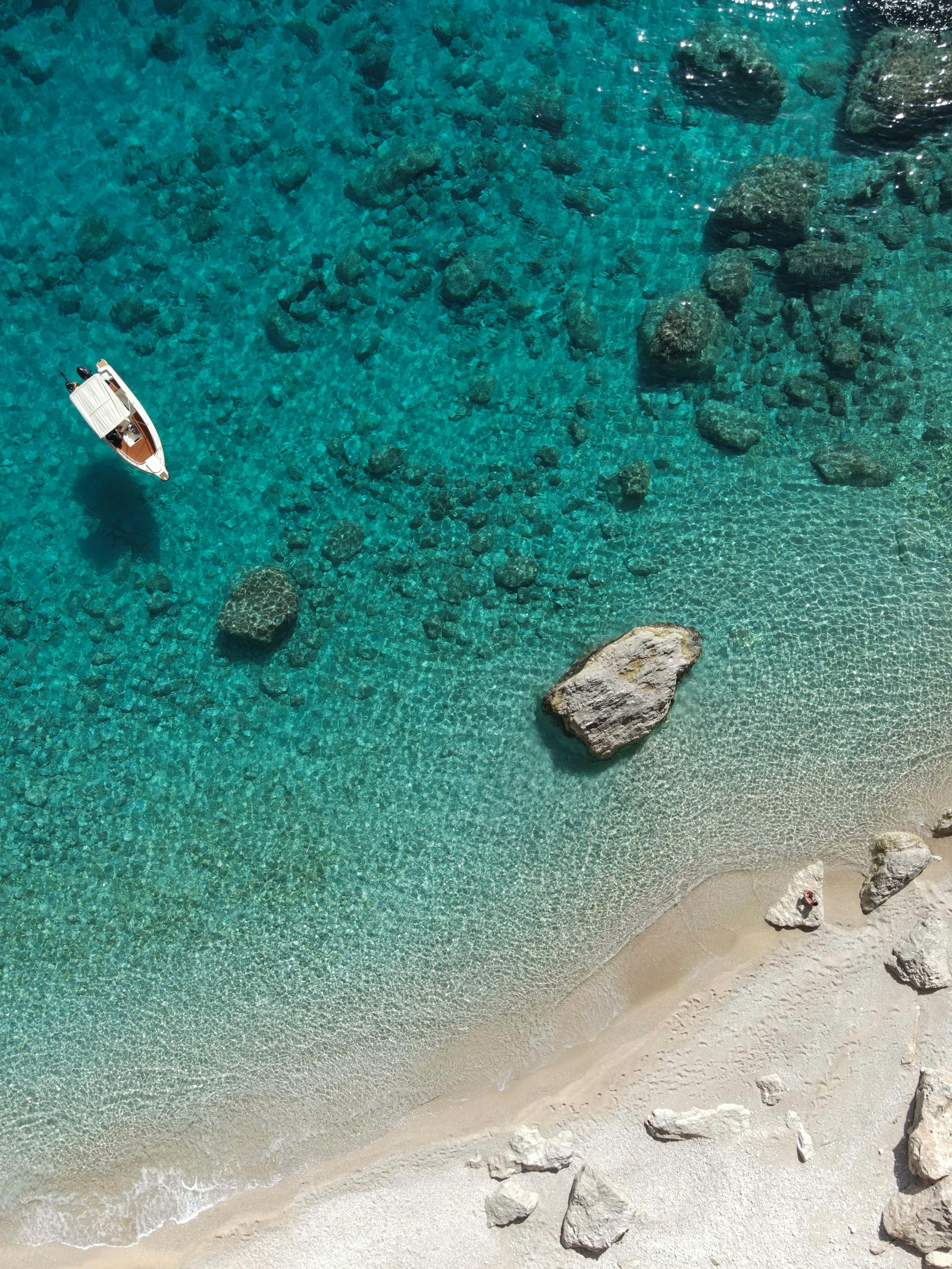 Aerial view of a boat on turquoise Zakynthos water